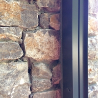 Surface mount track on stone column.